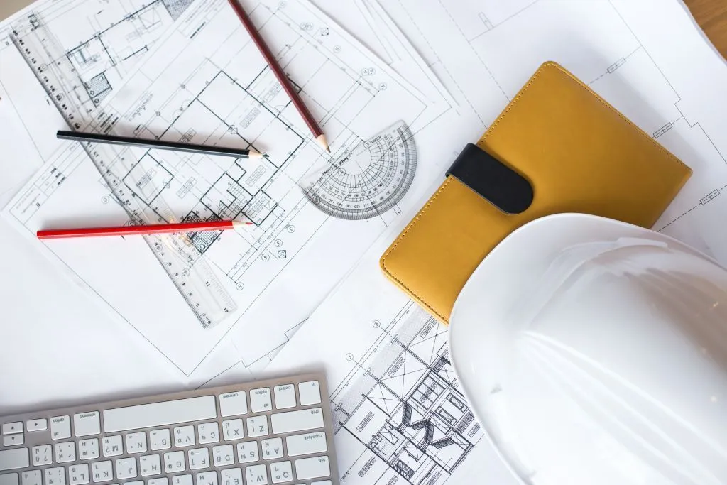 image-of-blueprints-with-level-pencil-and-hard-hat-on-table.jpg чертеж
